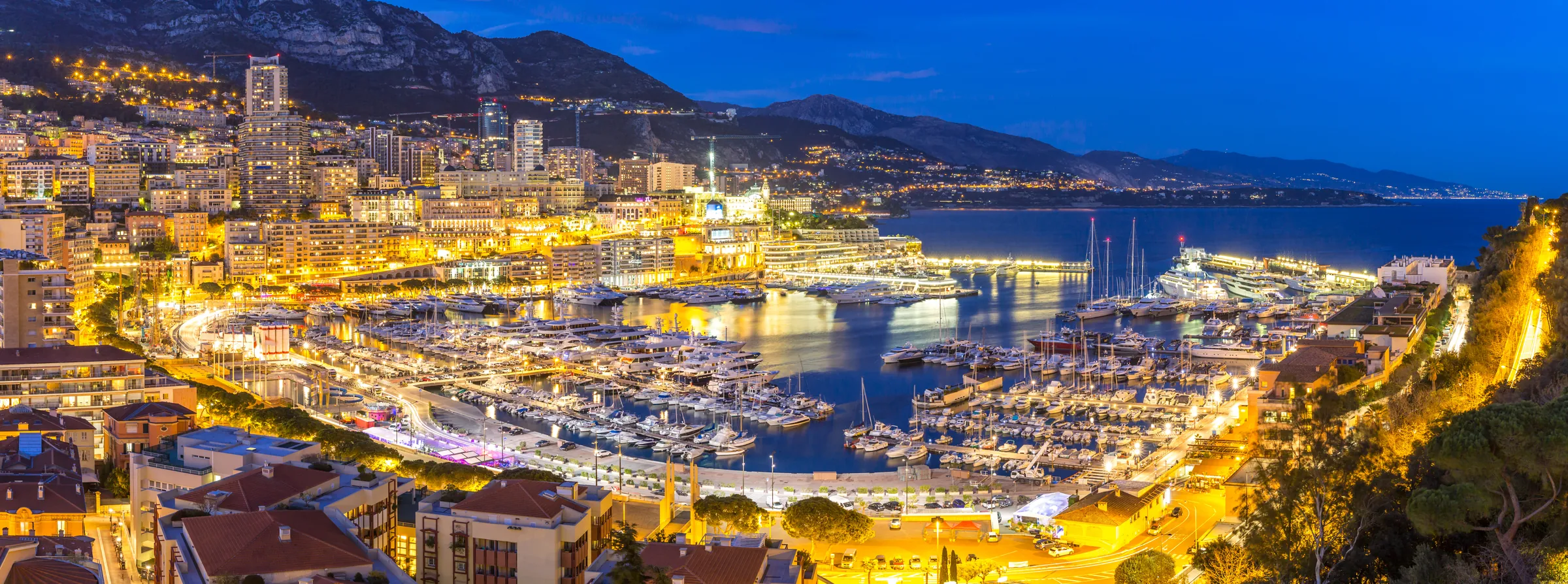 Monaco harbour at night, lit up over Port Hercule